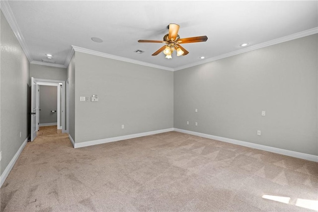 carpeted empty room with crown molding and ceiling fan