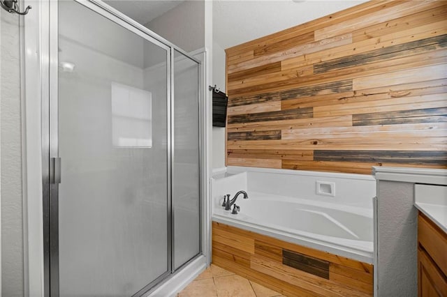 bathroom featuring tile patterned flooring, wood walls, vanity, and plus walk in shower