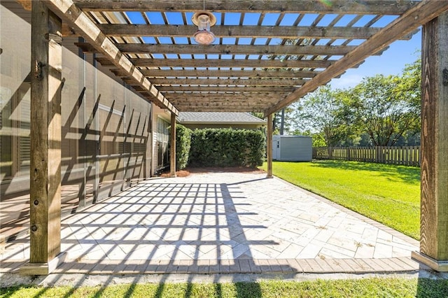 view of patio / terrace with a shed and a pergola