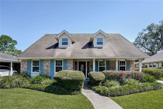 cape cod home with a front yard