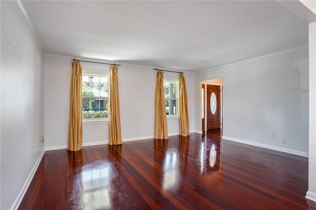 empty room featuring ornamental molding and dark hardwood / wood-style flooring