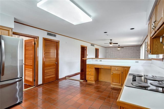 kitchen with ceiling fan, dark tile patterned floors, kitchen peninsula, stainless steel refrigerator, and black electric stovetop