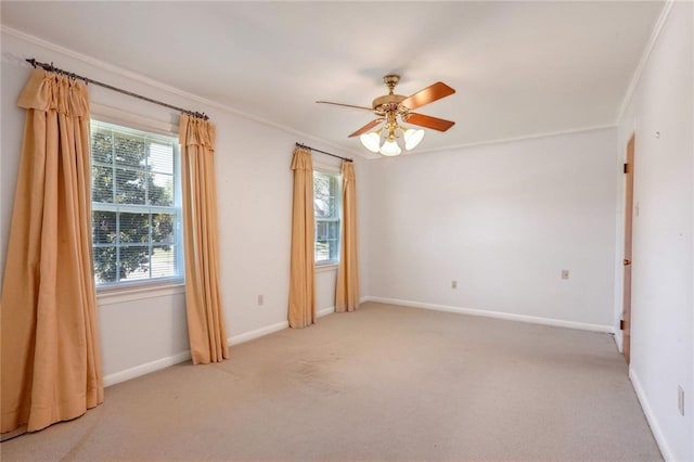 carpeted empty room with crown molding and ceiling fan