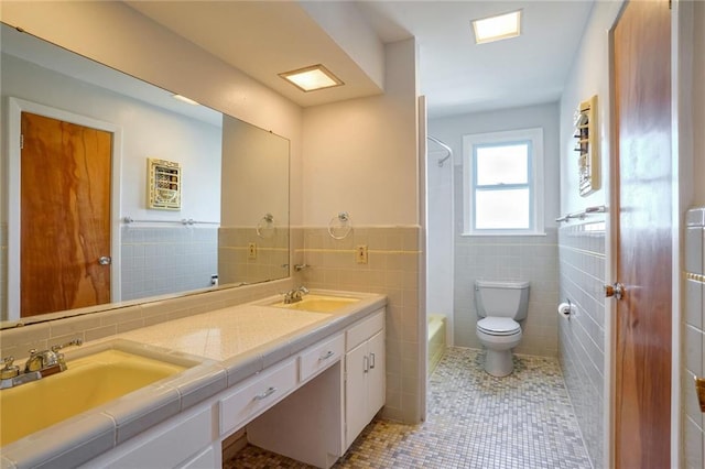 bathroom with tile walls, tile patterned floors, vanity, and toilet