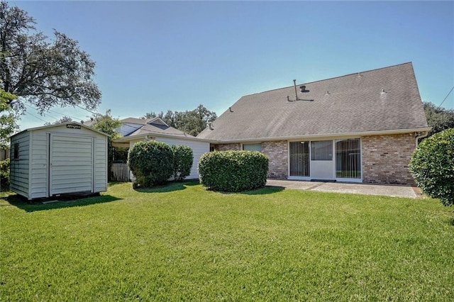 rear view of house featuring a yard and a shed