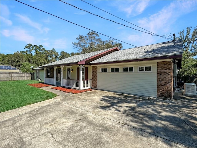 ranch-style house featuring central air condition unit, a porch, a front yard, and a garage