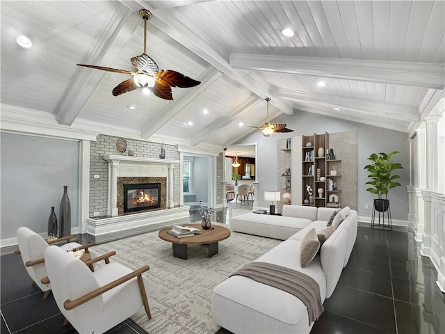 tiled living room with ceiling fan, lofted ceiling with beams, plenty of natural light, and decorative columns