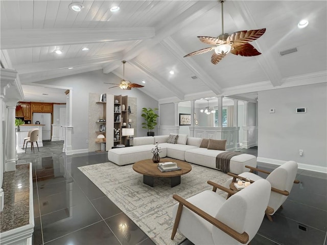 living room featuring ornate columns, ceiling fan with notable chandelier, dark tile patterned floors, and lofted ceiling with beams