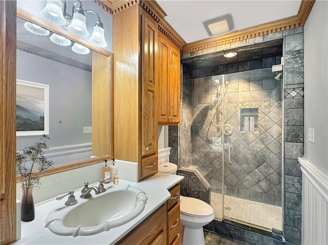 bathroom with a shower with shower door, vanity, and toilet