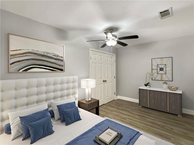 bedroom with ceiling fan, a closet, and dark hardwood / wood-style floors