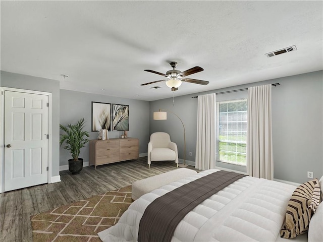 bedroom with ceiling fan and dark hardwood / wood-style flooring