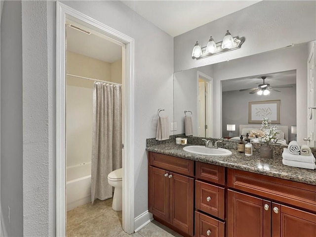 full bathroom with ceiling fan, shower / tub combo, vanity, tile patterned floors, and toilet