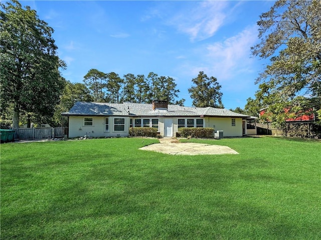 back of property featuring a yard and a patio