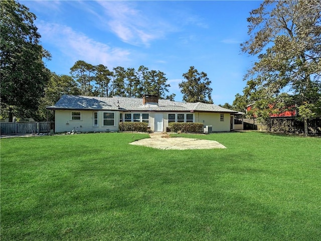 back of property featuring a yard and a patio area