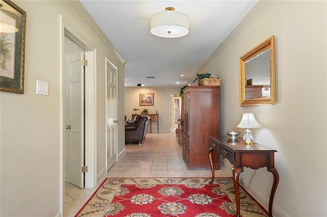 hall featuring light tile patterned flooring and ornamental molding