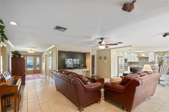 living room with ceiling fan, light tile patterned floors, and ornamental molding