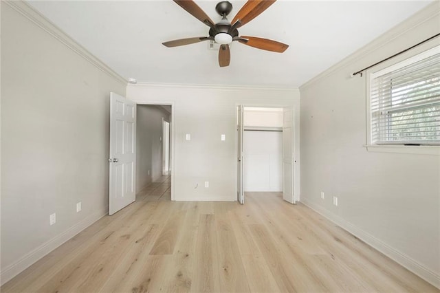 unfurnished bedroom with a closet, crown molding, light hardwood / wood-style flooring, and ceiling fan