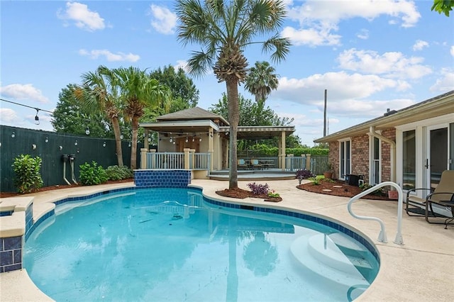 view of swimming pool with a patio and pool water feature