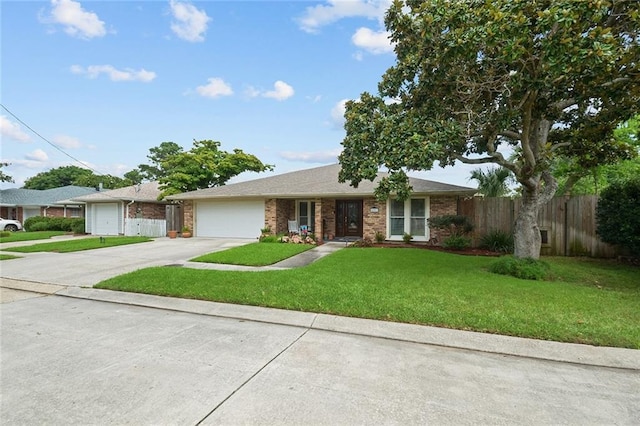 ranch-style home with a front lawn and a garage