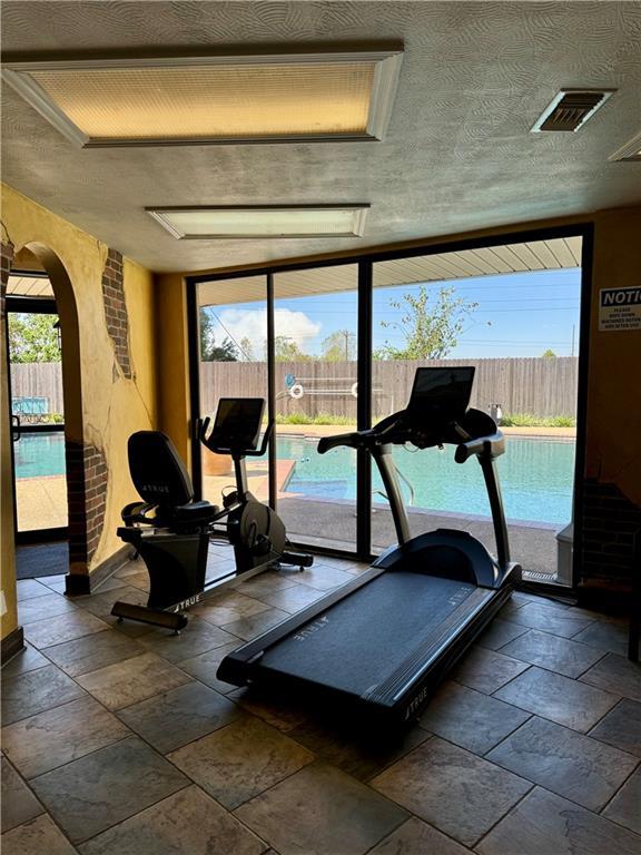 exercise area with a textured ceiling and a wealth of natural light