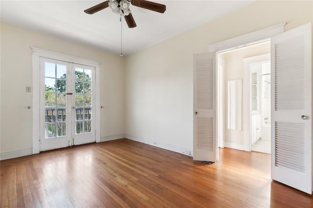 empty room with ceiling fan and hardwood / wood-style floors