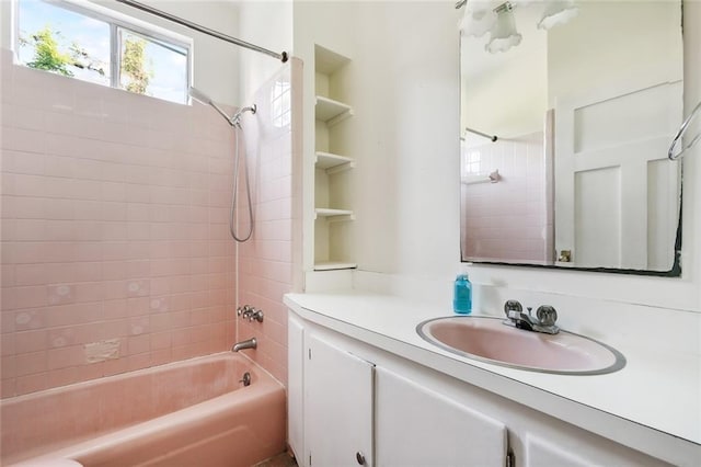 bathroom with vanity and tiled shower / bath combo