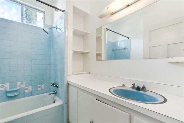 bathroom featuring tiled shower / bath combo and vanity