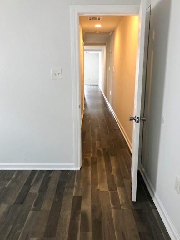 corridor featuring dark hardwood / wood-style floors