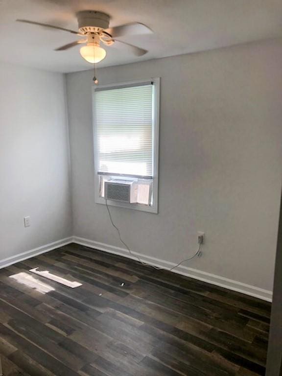 unfurnished room featuring ceiling fan, dark hardwood / wood-style floors, and cooling unit