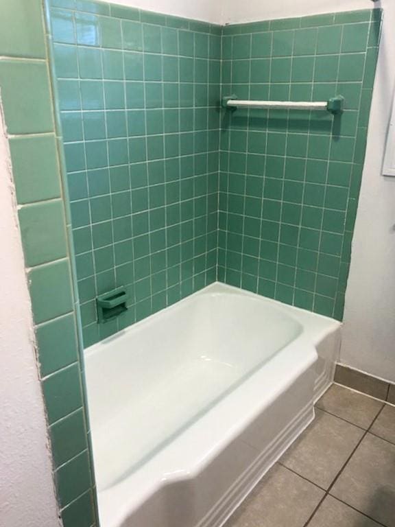 bathroom with tile patterned flooring and tiled shower / bath