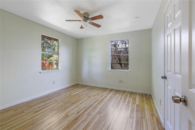 unfurnished room with light wood-type flooring and ceiling fan