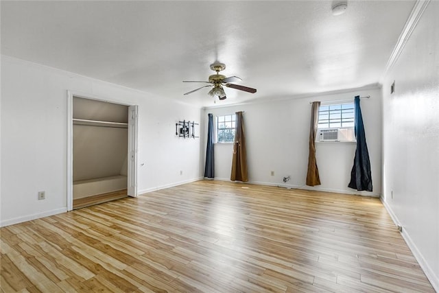 unfurnished bedroom with ornamental molding, light wood-type flooring, multiple windows, and ceiling fan