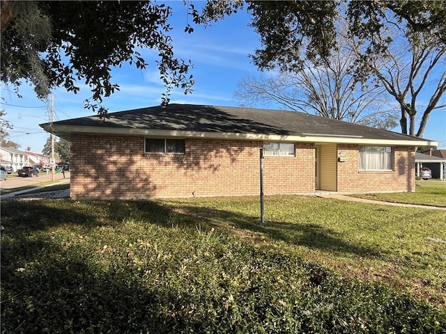 rear view of property featuring a lawn