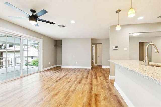 2109 Airline Park Blvd, Metairie, LA 70003 - unfurnished living room featuring a sink, light wood finished floors, baseboards, a ceiling fan, and recessed lighting