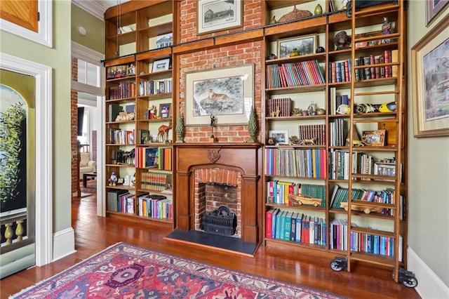 living area with dark hardwood / wood-style floors and ornamental molding