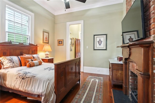 bedroom with ceiling fan, a brick fireplace, dark hardwood / wood-style floors, and ornamental molding