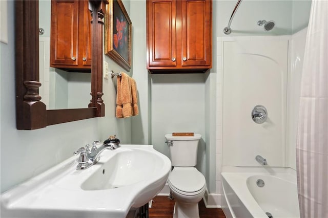 bathroom featuring shower / bath combination with curtain and toilet