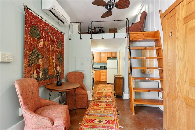 interior space with an AC wall unit, washer / dryer, and ceiling fan