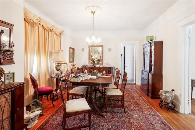 dining room with an inviting chandelier and hardwood / wood-style floors