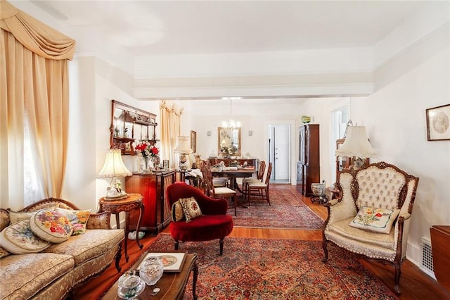 living room featuring a notable chandelier and hardwood / wood-style flooring