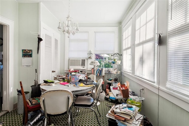 sunroom featuring cooling unit, a notable chandelier, and a healthy amount of sunlight