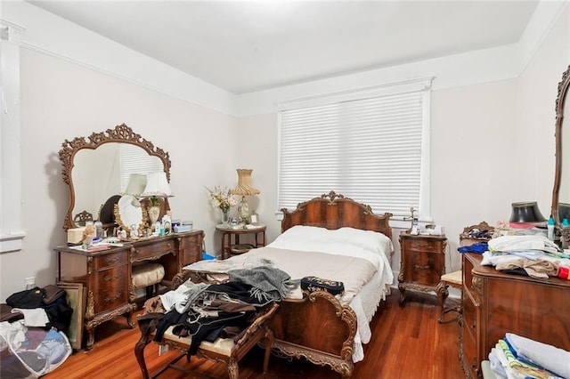 bedroom with dark hardwood / wood-style flooring