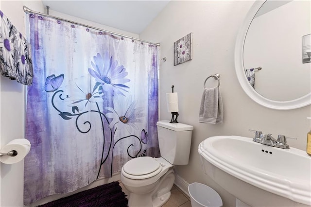 bathroom with sink, tile patterned flooring, toilet, and curtained shower