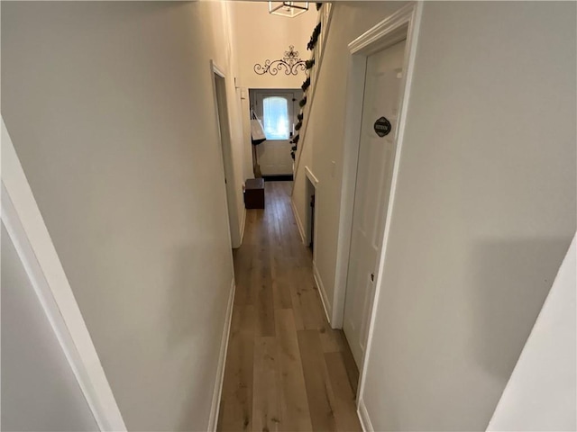 hallway with hardwood / wood-style flooring