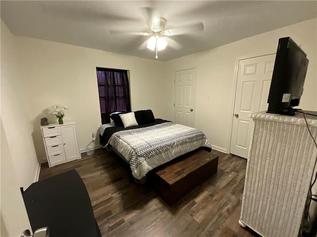 bedroom with dark hardwood / wood-style flooring and ceiling fan