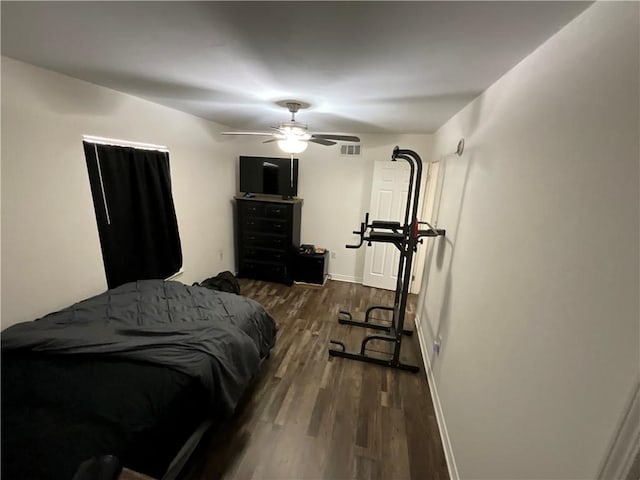 bedroom with dark hardwood / wood-style flooring and ceiling fan