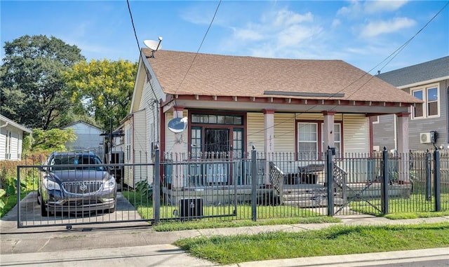 bungalow with a front lawn and covered porch