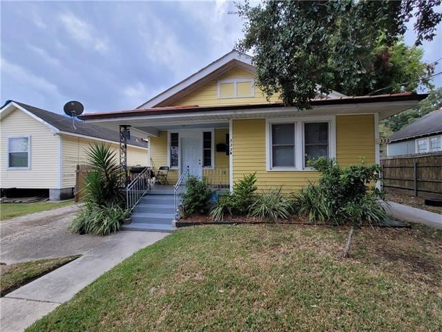 bungalow-style house with a front yard and a porch