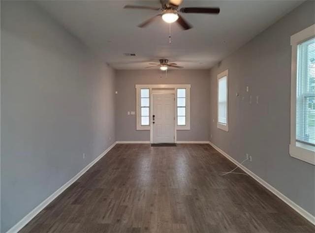 entryway with ceiling fan, dark hardwood / wood-style flooring, and a healthy amount of sunlight