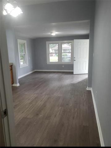 unfurnished room with dark hardwood / wood-style floors